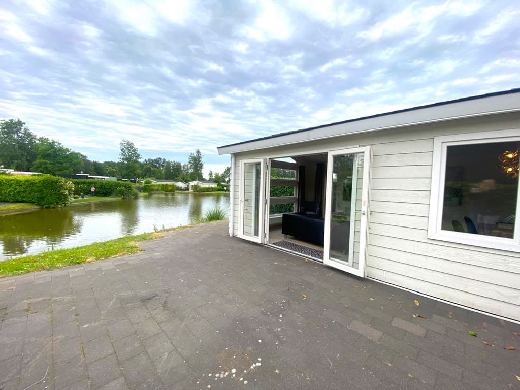 Vakantiewoning aan het water met panorama-ramen en een betegelde oprit in EuroParcs Spaarnwoude, Halfweg.