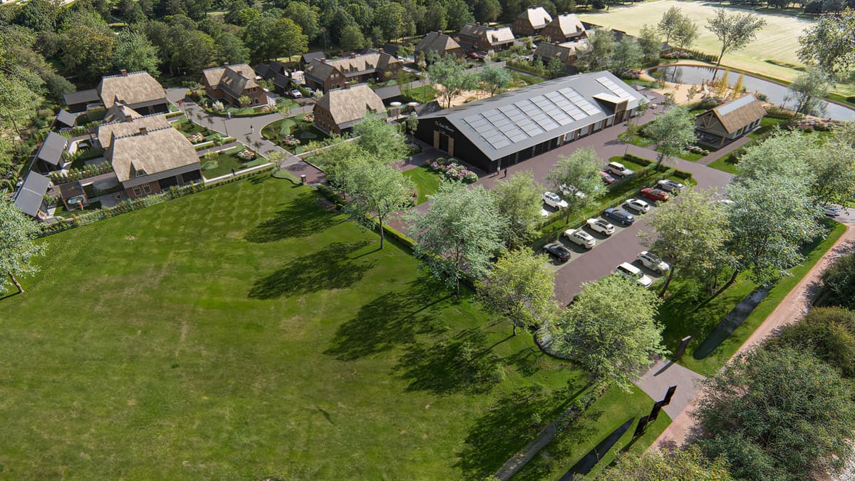 Uitzicht op een woonwijk met moderne woningen, parkeerplaatsen en groene ruimtes omgeven door bomen en een veld.