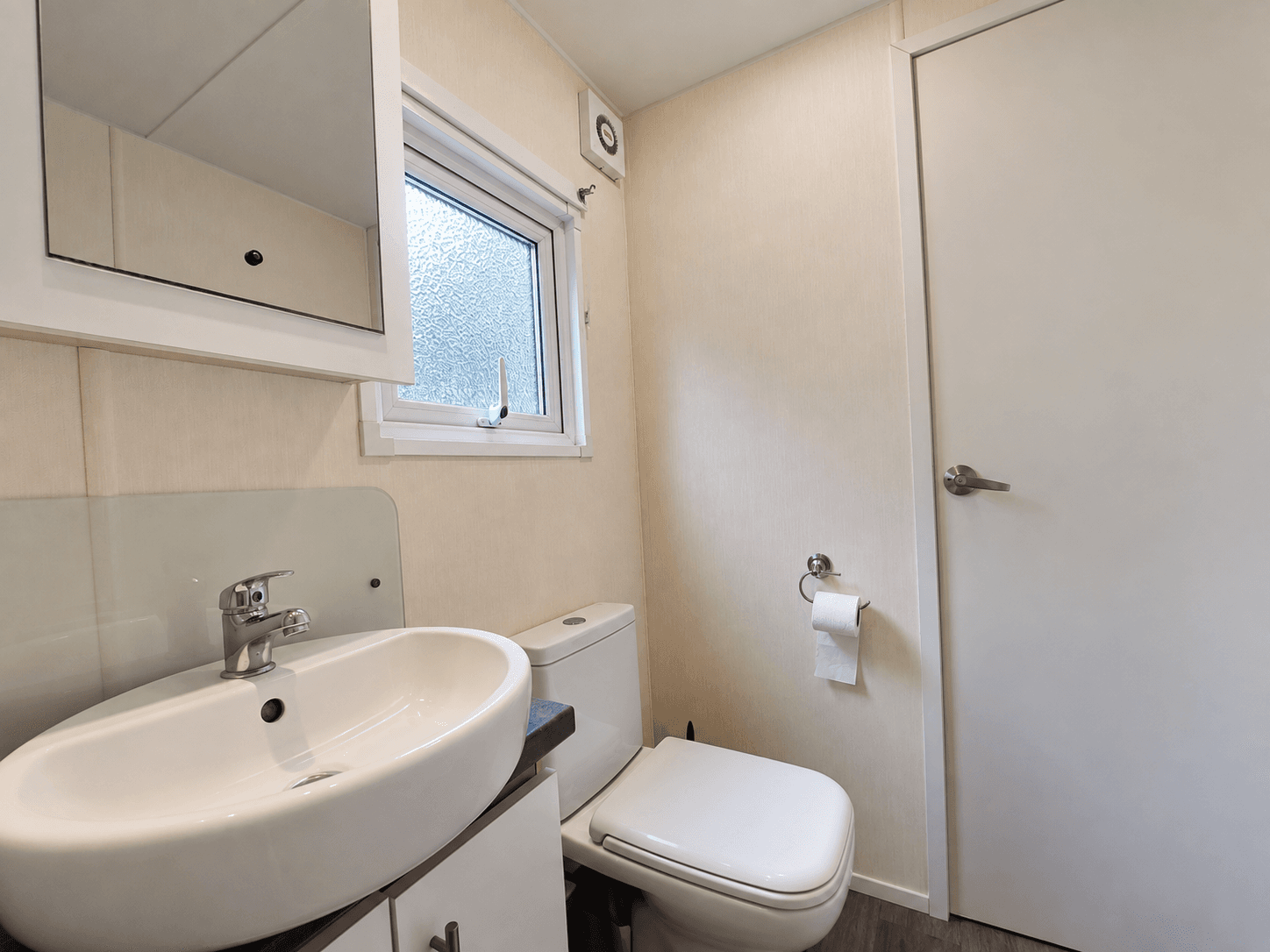 Moderne badkamer met toilet, wastafel en raam voor natuurlijk licht
