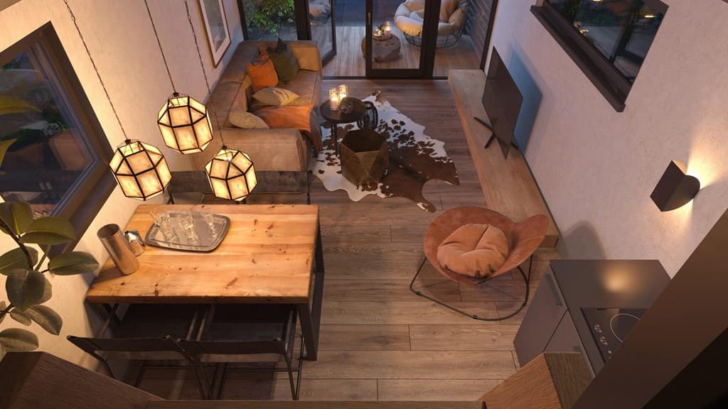 Gezellige loungehoek met comfortabele banken, eettafel, moderne stoelen en warme verlichting in een vakantiehuis.