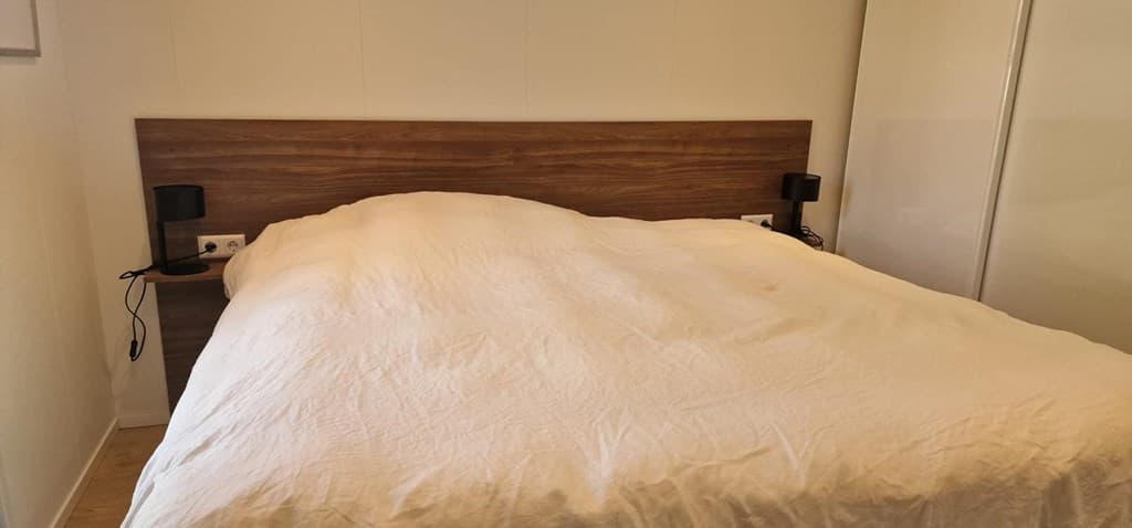 slaapkamer met een groot bed en nachtkastjes aan beide zijden
